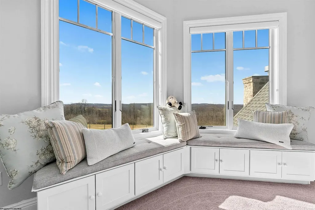 2536 Halleck Road Home in Morgantown, West Virginia. Discover the epitome of secluded luxury living with this sprawling estate nestled on 20+ acres of stunning West Virginia landscape. With over 9,500 square feet spread across three floors, this meticulously designed home offers 4 or 5 bedrooms, 5 full and 4 half bathrooms, and a refined color palette that sets the stage for elegant furnishings. The chef's kitchen features top-of-the-line Sub Zero and Wolf appliances, custom cabinetry, and a hidden walk-in pantry. 