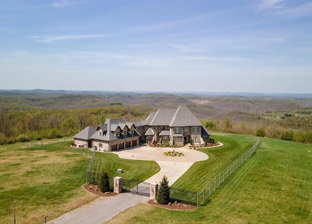 2536 Halleck Road Home in Morgantown, West Virginia. Discover the epitome of secluded luxury living with this sprawling estate nestled on 20+ acres of stunning West Virginia landscape. With over 9,500 square feet spread across three floors, this meticulously designed home offers 4 or 5 bedrooms, 5 full and 4 half bathrooms, and a refined color palette that sets the stage for elegant furnishings. The chef's kitchen features top-of-the-line Sub Zero and Wolf appliances, custom cabinetry, and a hidden walk-in pantry. 