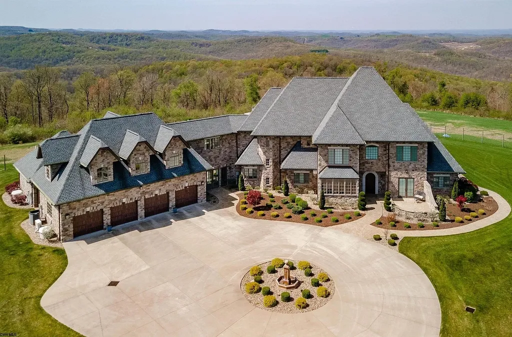 2536 Halleck Road Home in Morgantown, West Virginia. Discover the epitome of secluded luxury living with this sprawling estate nestled on 20+ acres of stunning West Virginia landscape. With over 9,500 square feet spread across three floors, this meticulously designed home offers 4 or 5 bedrooms, 5 full and 4 half bathrooms, and a refined color palette that sets the stage for elegant furnishings. The chef's kitchen features top-of-the-line Sub Zero and Wolf appliances, custom cabinetry, and a hidden walk-in pantry. 