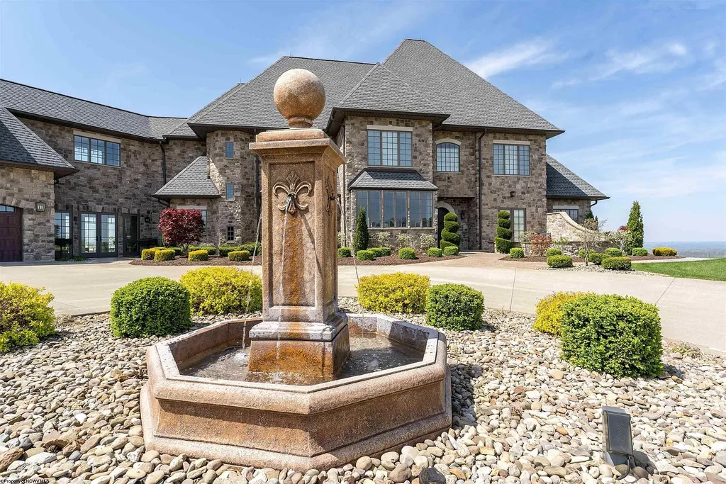 2536 Halleck Road Home in Morgantown, West Virginia. Discover the epitome of secluded luxury living with this sprawling estate nestled on 20+ acres of stunning West Virginia landscape. With over 9,500 square feet spread across three floors, this meticulously designed home offers 4 or 5 bedrooms, 5 full and 4 half bathrooms, and a refined color palette that sets the stage for elegant furnishings. The chef's kitchen features top-of-the-line Sub Zero and Wolf appliances, custom cabinetry, and a hidden walk-in pantry. 