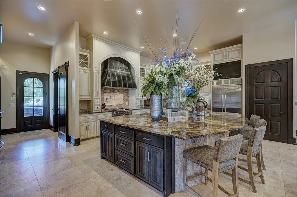 3507 Hillview Drive Home in Drive, Norman, Oklahoma. The home boasts picturesque views from the moment you approach it. Some of its exceptional features include a massive, aerated, and stocked pond that holds approximately 1 million gallons of water, premium finishes and appliances throughout, travertine flooring, two laundry rooms, rare and unique granite, 10-foot garage doors, a hydraulic elevator, spray foam insulation, automatic lighting in every closet, and a hot water recirculating system.