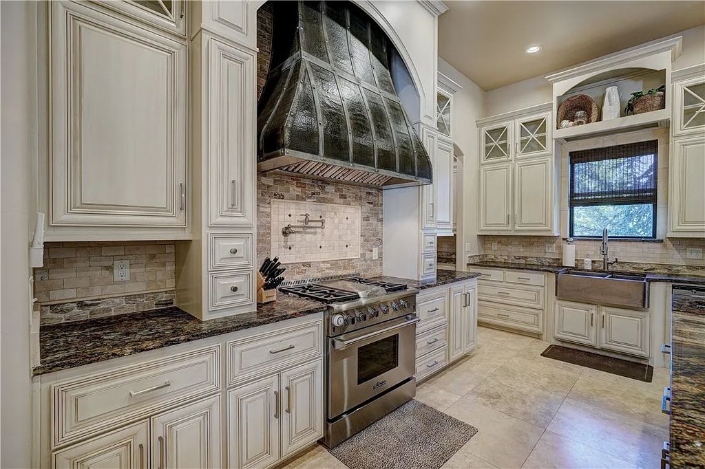 3507 Hillview Drive Home in Drive, Norman, Oklahoma. The home boasts picturesque views from the moment you approach it. Some of its exceptional features include a massive, aerated, and stocked pond that holds approximately 1 million gallons of water, premium finishes and appliances throughout, travertine flooring, two laundry rooms, rare and unique granite, 10-foot garage doors, a hydraulic elevator, spray foam insulation, automatic lighting in every closet, and a hot water recirculating system.