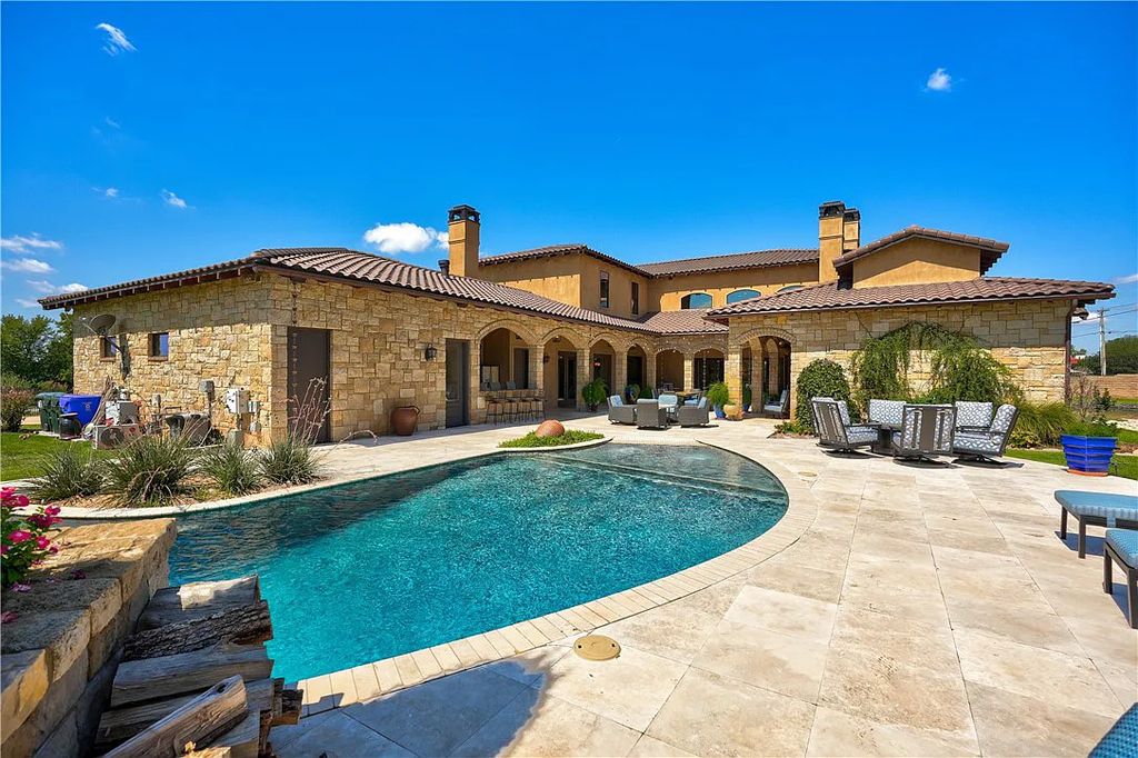 3507 Hillview Drive Home in Drive, Norman, Oklahoma. The home boasts picturesque views from the moment you approach it. Some of its exceptional features include a massive, aerated, and stocked pond that holds approximately 1 million gallons of water, premium finishes and appliances throughout, travertine flooring, two laundry rooms, rare and unique granite, 10-foot garage doors, a hydraulic elevator, spray foam insulation, automatic lighting in every closet, and a hot water recirculating system.