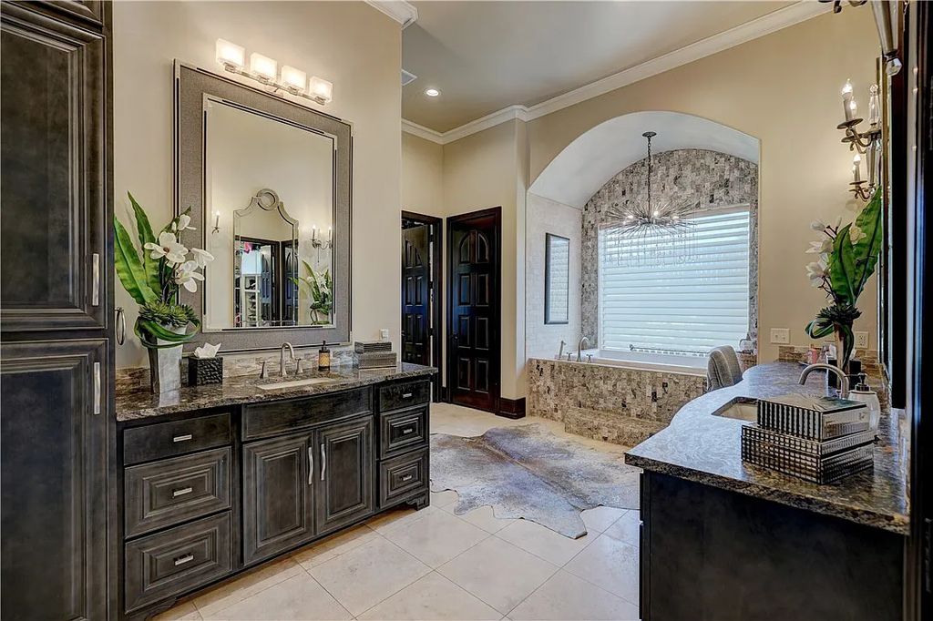 3507 Hillview Drive Home in Drive, Norman, Oklahoma. The home boasts picturesque views from the moment you approach it. Some of its exceptional features include a massive, aerated, and stocked pond that holds approximately 1 million gallons of water, premium finishes and appliances throughout, travertine flooring, two laundry rooms, rare and unique granite, 10-foot garage doors, a hydraulic elevator, spray foam insulation, automatic lighting in every closet, and a hot water recirculating system.