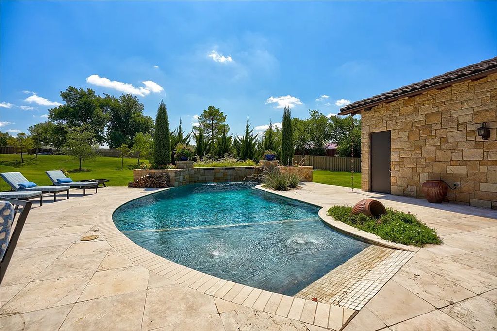 3507 Hillview Drive Home in Drive, Norman, Oklahoma. The home boasts picturesque views from the moment you approach it. Some of its exceptional features include a massive, aerated, and stocked pond that holds approximately 1 million gallons of water, premium finishes and appliances throughout, travertine flooring, two laundry rooms, rare and unique granite, 10-foot garage doors, a hydraulic elevator, spray foam insulation, automatic lighting in every closet, and a hot water recirculating system.