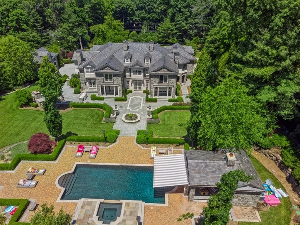 363 Lydecker Street Home in Englewood, New Jersey. This magnificent estate captivates with its stunning granite stone exterior, slate roof, and copper gutters. Inside, indulge in opulent amenities including a Christopher Peacock kitchen, media room, and library with an attached 5-car garage gallery. The home features a complete Crestron home automation and security system, a 3000-bottle wine cellar, elevator, and 9 fireplaces.