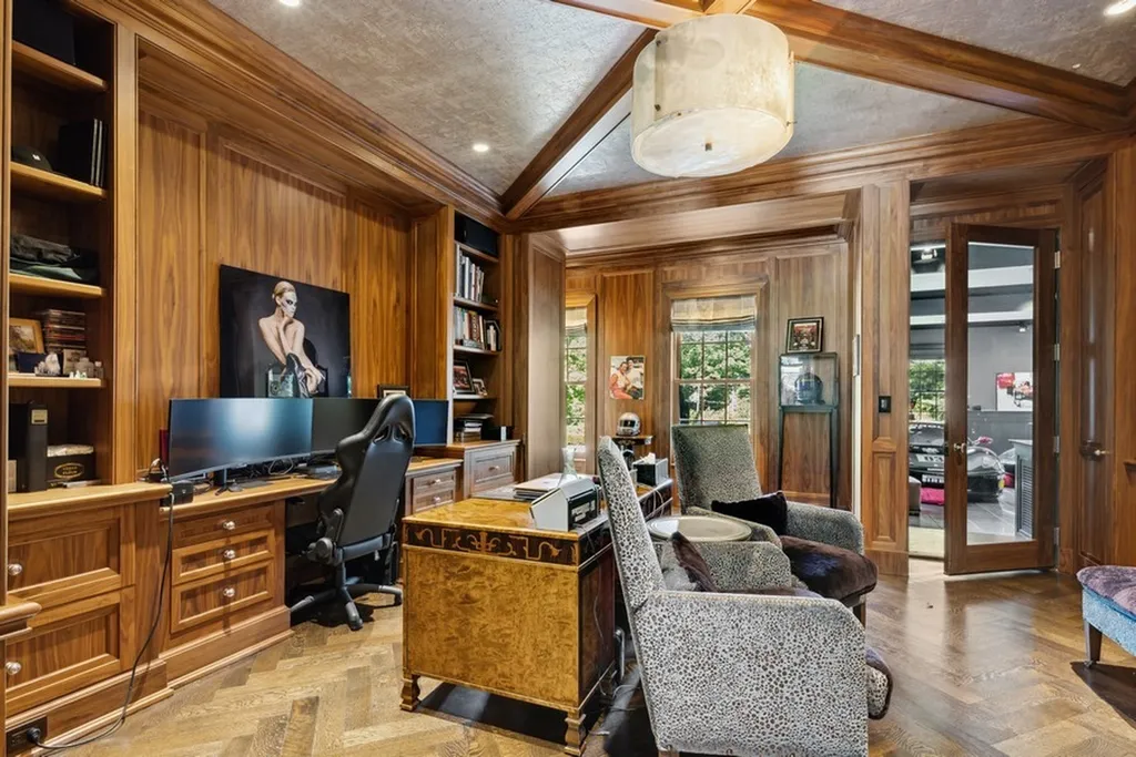363 Lydecker Street Home in Englewood, New Jersey. This magnificent estate captivates with its stunning granite stone exterior, slate roof, and copper gutters. Inside, indulge in opulent amenities including a Christopher Peacock kitchen, media room, and library with an attached 5-car garage gallery. The home features a complete Crestron home automation and security system, a 3000-bottle wine cellar, elevator, and 9 fireplaces.