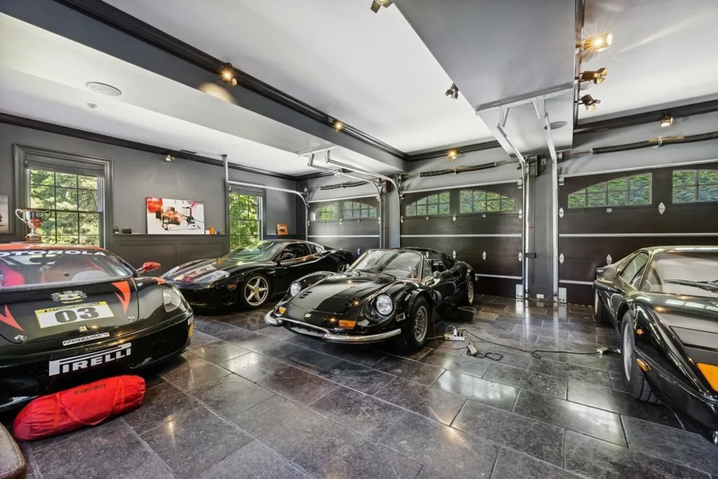 363 Lydecker Street Home in Englewood, New Jersey. This magnificent estate captivates with its stunning granite stone exterior, slate roof, and copper gutters. Inside, indulge in opulent amenities including a Christopher Peacock kitchen, media room, and library with an attached 5-car garage gallery. The home features a complete Crestron home automation and security system, a 3000-bottle wine cellar, elevator, and 9 fireplaces.