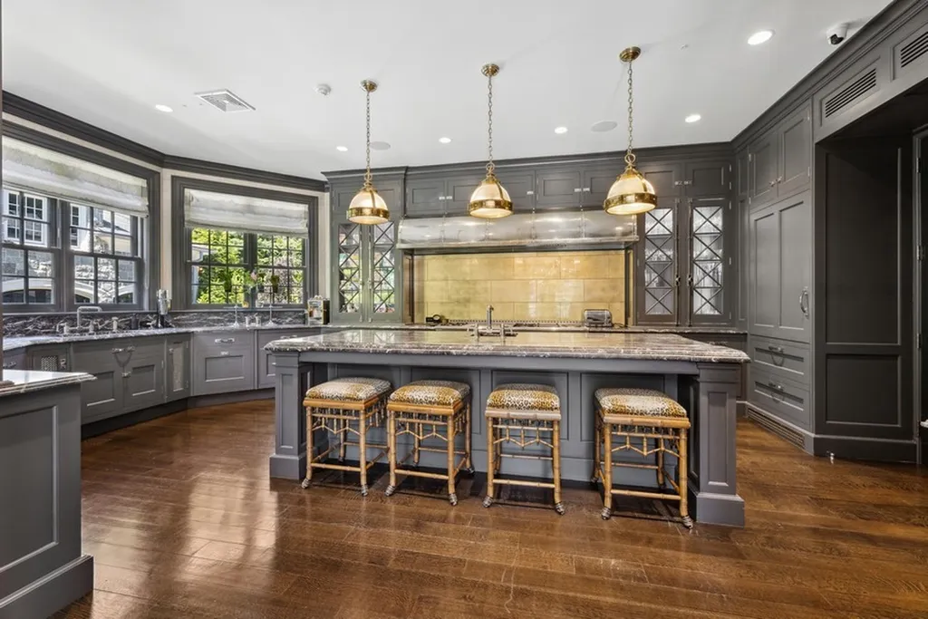 363 Lydecker Street Home in Englewood, New Jersey. This magnificent estate captivates with its stunning granite stone exterior, slate roof, and copper gutters. Inside, indulge in opulent amenities including a Christopher Peacock kitchen, media room, and library with an attached 5-car garage gallery. The home features a complete Crestron home automation and security system, a 3000-bottle wine cellar, elevator, and 9 fireplaces.