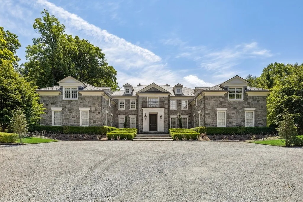 363 Lydecker Street Home in Englewood, New Jersey. This magnificent estate captivates with its stunning granite stone exterior, slate roof, and copper gutters. Inside, indulge in opulent amenities including a Christopher Peacock kitchen, media room, and library with an attached 5-car garage gallery. The home features a complete Crestron home automation and security system, a 3000-bottle wine cellar, elevator, and 9 fireplaces.