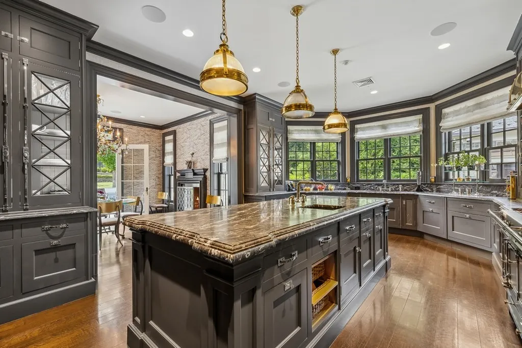 363 Lydecker Street Home in Englewood, New Jersey. This magnificent estate captivates with its stunning granite stone exterior, slate roof, and copper gutters. Inside, indulge in opulent amenities including a Christopher Peacock kitchen, media room, and library with an attached 5-car garage gallery. The home features a complete Crestron home automation and security system, a 3000-bottle wine cellar, elevator, and 9 fireplaces.