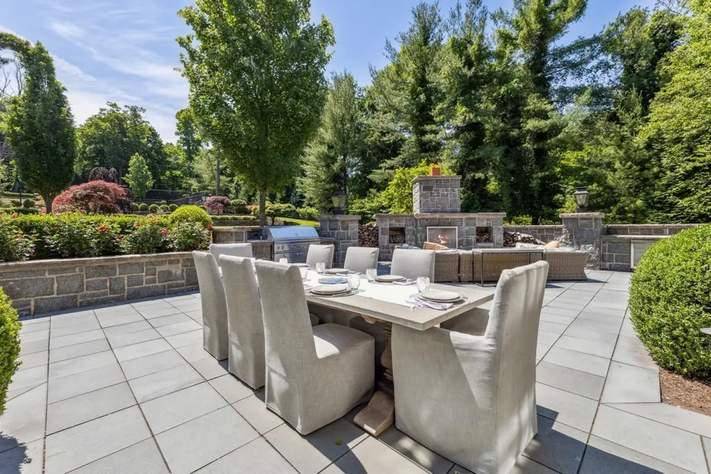 363 Lydecker Street Home in Englewood, New Jersey. This magnificent estate captivates with its stunning granite stone exterior, slate roof, and copper gutters. Inside, indulge in opulent amenities including a Christopher Peacock kitchen, media room, and library with an attached 5-car garage gallery. The home features a complete Crestron home automation and security system, a 3000-bottle wine cellar, elevator, and 9 fireplaces.
