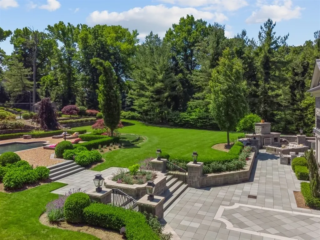 363 Lydecker Street Home in Englewood, New Jersey. This magnificent estate captivates with its stunning granite stone exterior, slate roof, and copper gutters. Inside, indulge in opulent amenities including a Christopher Peacock kitchen, media room, and library with an attached 5-car garage gallery. The home features a complete Crestron home automation and security system, a 3000-bottle wine cellar, elevator, and 9 fireplaces.
