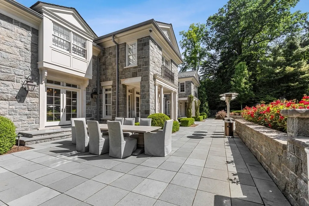 363 Lydecker Street Home in Englewood, New Jersey. This magnificent estate captivates with its stunning granite stone exterior, slate roof, and copper gutters. Inside, indulge in opulent amenities including a Christopher Peacock kitchen, media room, and library with an attached 5-car garage gallery. The home features a complete Crestron home automation and security system, a 3000-bottle wine cellar, elevator, and 9 fireplaces.