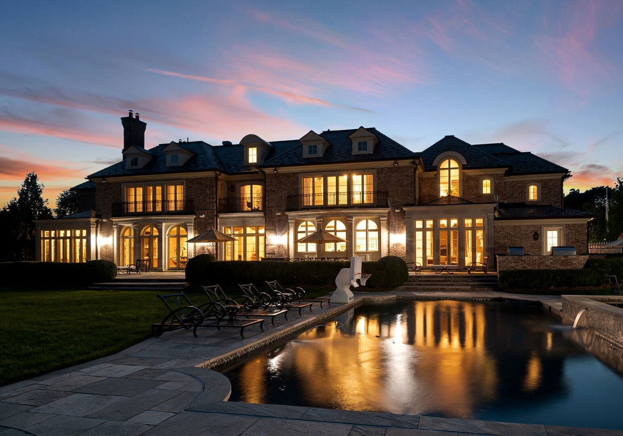 4 Stone Tower Drive Home in Alpine, New Jersey. Discover the epitome of luxury living at the majestic Alpine estate, one of the finest homes in Northern Bergen County. Set on 4 gated manicured acres in Rio Vista, this impeccably designed manor by James Paragono showcases architectural excellence and meticulous craftsmanship. With 22,782 square feet of opulent living space spread across 4 levels, this estate boasts 12' ceilings, luxurious amenities, and breathtaking features, including a pool, cabana, tennis court, guest house, and putting green. The residence offers garage parking for 8 cars, an elevator servicing all floors, 25 rooms, a new Salerno kitchen, 8 bedrooms, 9 full and 3 half baths, bowling alleys, a home theater, a commercial generator, and state-of-the-art high-efficiency furnaces.