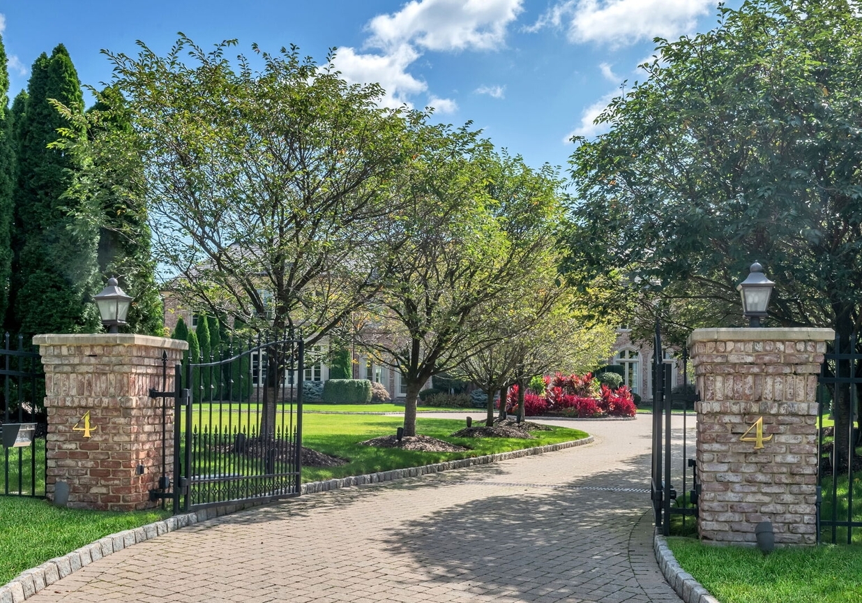 4 Stone Tower Drive Home in Alpine, New Jersey. Discover the epitome of luxury living at the majestic Alpine estate, one of the finest homes in Northern Bergen County. Set on 4 gated manicured acres in Rio Vista, this impeccably designed manor by James Paragono showcases architectural excellence and meticulous craftsmanship. With 22,782 square feet of opulent living space spread across 4 levels, this estate boasts 12' ceilings, luxurious amenities, and breathtaking features, including a pool, cabana, tennis court, guest house, and putting green. The residence offers garage parking for 8 cars, an elevator servicing all floors, 25 rooms, a new Salerno kitchen, 8 bedrooms, 9 full and 3 half baths, bowling alleys, a home theater, a commercial generator, and state-of-the-art high-efficiency furnaces.