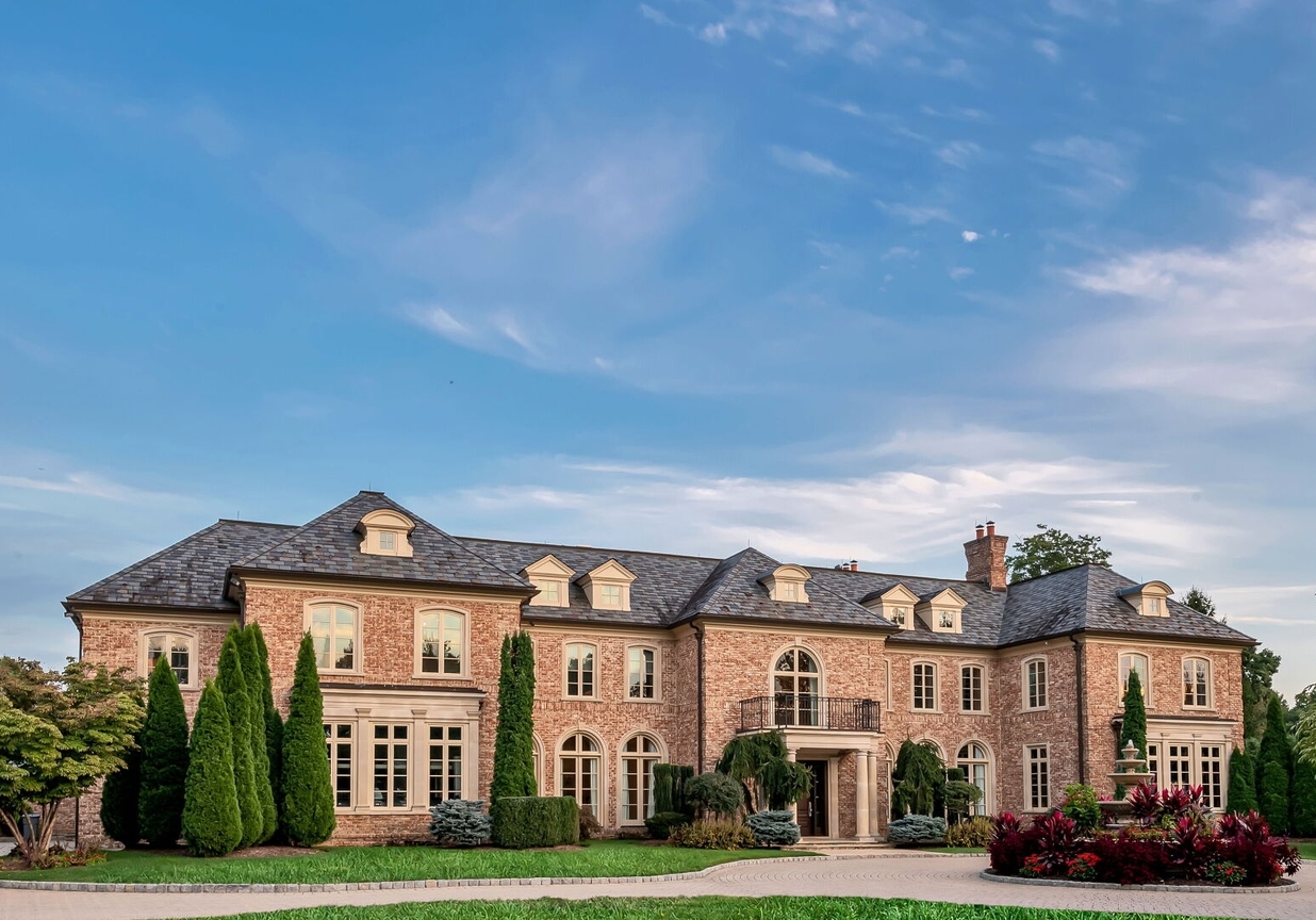 4 Stone Tower Drive Home in Alpine, New Jersey. Discover the epitome of luxury living at the majestic Alpine estate, one of the finest homes in Northern Bergen County. Set on 4 gated manicured acres in Rio Vista, this impeccably designed manor by James Paragono showcases architectural excellence and meticulous craftsmanship. With 22,782 square feet of opulent living space spread across 4 levels, this estate boasts 12' ceilings, luxurious amenities, and breathtaking features, including a pool, cabana, tennis court, guest house, and putting green. The residence offers garage parking for 8 cars, an elevator servicing all floors, 25 rooms, a new Salerno kitchen, 8 bedrooms, 9 full and 3 half baths, bowling alleys, a home theater, a commercial generator, and state-of-the-art high-efficiency furnaces.