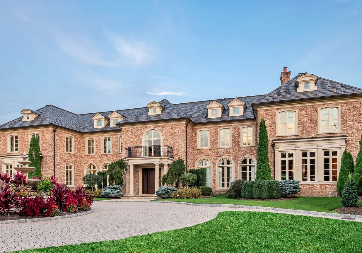 4 Stone Tower Drive Home in Alpine, New Jersey. Discover the epitome of luxury living at the majestic Alpine estate, one of the finest homes in Northern Bergen County. Set on 4 gated manicured acres in Rio Vista, this impeccably designed manor by James Paragono showcases architectural excellence and meticulous craftsmanship. With 22,782 square feet of opulent living space spread across 4 levels, this estate boasts 12' ceilings, luxurious amenities, and breathtaking features, including a pool, cabana, tennis court, guest house, and putting green. The residence offers garage parking for 8 cars, an elevator servicing all floors, 25 rooms, a new Salerno kitchen, 8 bedrooms, 9 full and 3 half baths, bowling alleys, a home theater, a commercial generator, and state-of-the-art high-efficiency furnaces.