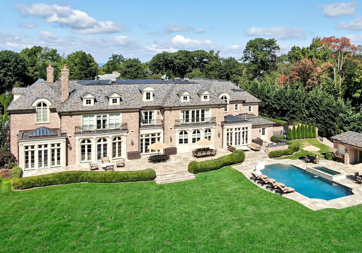 4 Stone Tower Drive Home in Alpine, New Jersey. Discover the epitome of luxury living at the majestic Alpine estate, one of the finest homes in Northern Bergen County. Set on 4 gated manicured acres in Rio Vista, this impeccably designed manor by James Paragono showcases architectural excellence and meticulous craftsmanship. With 22,782 square feet of opulent living space spread across 4 levels, this estate boasts 12' ceilings, luxurious amenities, and breathtaking features, including a pool, cabana, tennis court, guest house, and putting green. The residence offers garage parking for 8 cars, an elevator servicing all floors, 25 rooms, a new Salerno kitchen, 8 bedrooms, 9 full and 3 half baths, bowling alleys, a home theater, a commercial generator, and state-of-the-art high-efficiency furnaces.