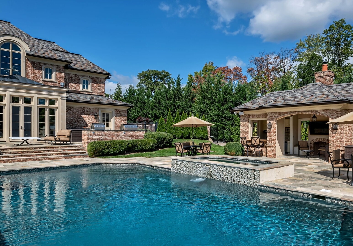 4 Stone Tower Drive Home in Alpine, New Jersey. Discover the epitome of luxury living at the majestic Alpine estate, one of the finest homes in Northern Bergen County. Set on 4 gated manicured acres in Rio Vista, this impeccably designed manor by James Paragono showcases architectural excellence and meticulous craftsmanship. With 22,782 square feet of opulent living space spread across 4 levels, this estate boasts 12' ceilings, luxurious amenities, and breathtaking features, including a pool, cabana, tennis court, guest house, and putting green. The residence offers garage parking for 8 cars, an elevator servicing all floors, 25 rooms, a new Salerno kitchen, 8 bedrooms, 9 full and 3 half baths, bowling alleys, a home theater, a commercial generator, and state-of-the-art high-efficiency furnaces.