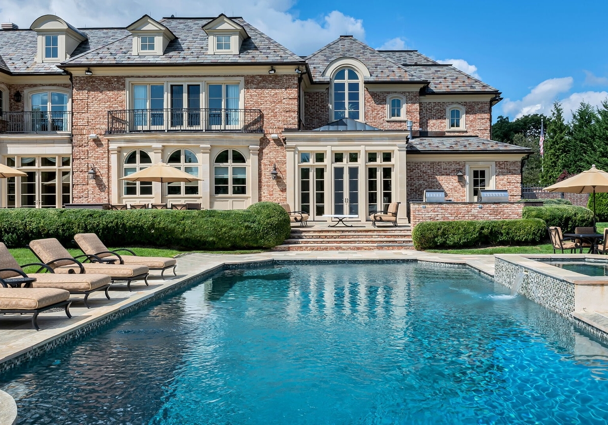 4 Stone Tower Drive Home in Alpine, New Jersey. Discover the epitome of luxury living at the majestic Alpine estate, one of the finest homes in Northern Bergen County. Set on 4 gated manicured acres in Rio Vista, this impeccably designed manor by James Paragono showcases architectural excellence and meticulous craftsmanship. With 22,782 square feet of opulent living space spread across 4 levels, this estate boasts 12' ceilings, luxurious amenities, and breathtaking features, including a pool, cabana, tennis court, guest house, and putting green. The residence offers garage parking for 8 cars, an elevator servicing all floors, 25 rooms, a new Salerno kitchen, 8 bedrooms, 9 full and 3 half baths, bowling alleys, a home theater, a commercial generator, and state-of-the-art high-efficiency furnaces.