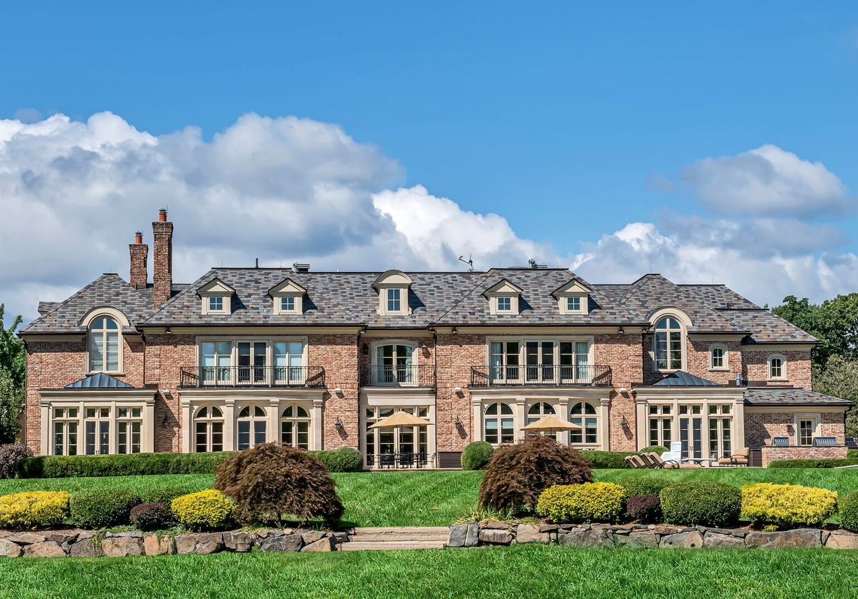 4 Stone Tower Drive Home in Alpine, New Jersey. Discover the epitome of luxury living at the majestic Alpine estate, one of the finest homes in Northern Bergen County. Set on 4 gated manicured acres in Rio Vista, this impeccably designed manor by James Paragono showcases architectural excellence and meticulous craftsmanship. With 22,782 square feet of opulent living space spread across 4 levels, this estate boasts 12' ceilings, luxurious amenities, and breathtaking features, including a pool, cabana, tennis court, guest house, and putting green. The residence offers garage parking for 8 cars, an elevator servicing all floors, 25 rooms, a new Salerno kitchen, 8 bedrooms, 9 full and 3 half baths, bowling alleys, a home theater, a commercial generator, and state-of-the-art high-efficiency furnaces.