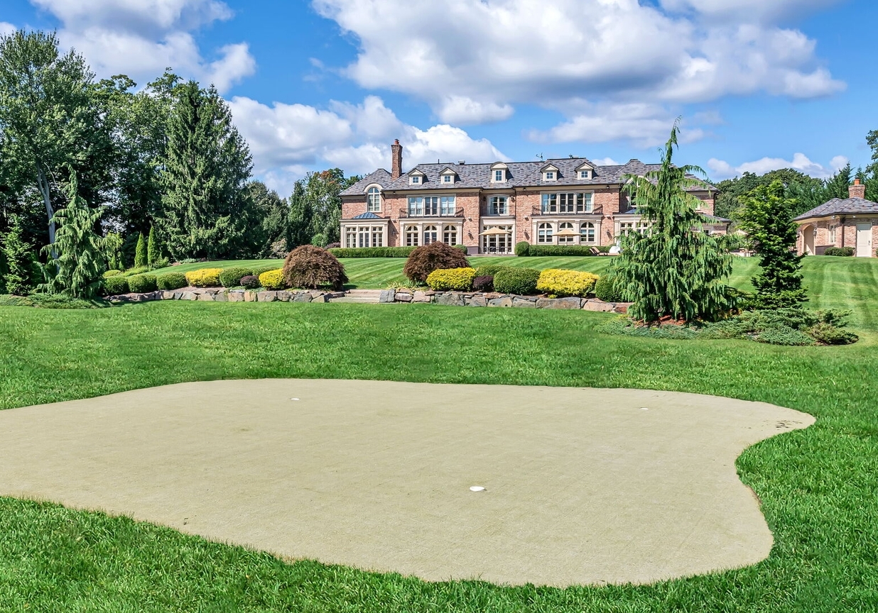 4 Stone Tower Drive Home in Alpine, New Jersey. Discover the epitome of luxury living at the majestic Alpine estate, one of the finest homes in Northern Bergen County. Set on 4 gated manicured acres in Rio Vista, this impeccably designed manor by James Paragono showcases architectural excellence and meticulous craftsmanship. With 22,782 square feet of opulent living space spread across 4 levels, this estate boasts 12' ceilings, luxurious amenities, and breathtaking features, including a pool, cabana, tennis court, guest house, and putting green. The residence offers garage parking for 8 cars, an elevator servicing all floors, 25 rooms, a new Salerno kitchen, 8 bedrooms, 9 full and 3 half baths, bowling alleys, a home theater, a commercial generator, and state-of-the-art high-efficiency furnaces.