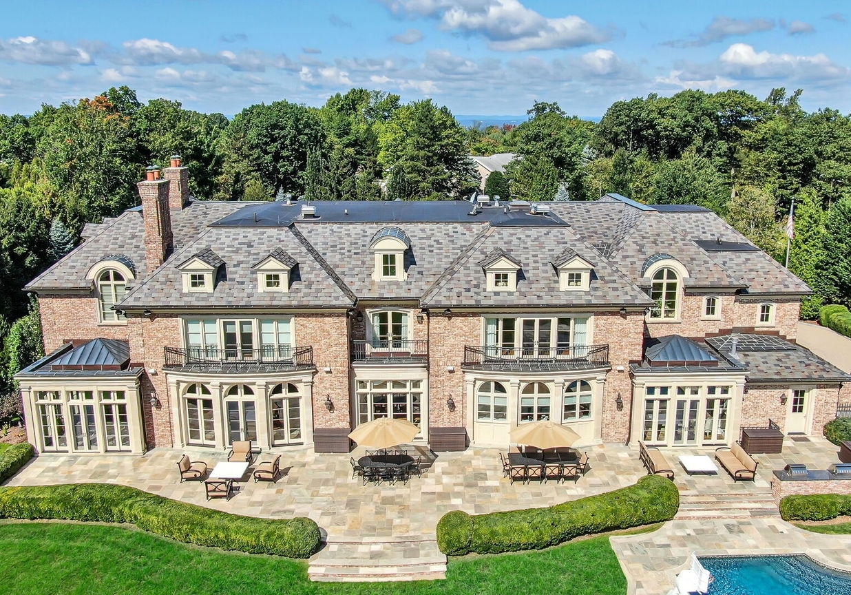 4 Stone Tower Drive Home in Alpine, New Jersey. Discover the epitome of luxury living at the majestic Alpine estate, one of the finest homes in Northern Bergen County. Set on 4 gated manicured acres in Rio Vista, this impeccably designed manor by James Paragono showcases architectural excellence and meticulous craftsmanship. With 22,782 square feet of opulent living space spread across 4 levels, this estate boasts 12' ceilings, luxurious amenities, and breathtaking features, including a pool, cabana, tennis court, guest house, and putting green. The residence offers garage parking for 8 cars, an elevator servicing all floors, 25 rooms, a new Salerno kitchen, 8 bedrooms, 9 full and 3 half baths, bowling alleys, a home theater, a commercial generator, and state-of-the-art high-efficiency furnaces.