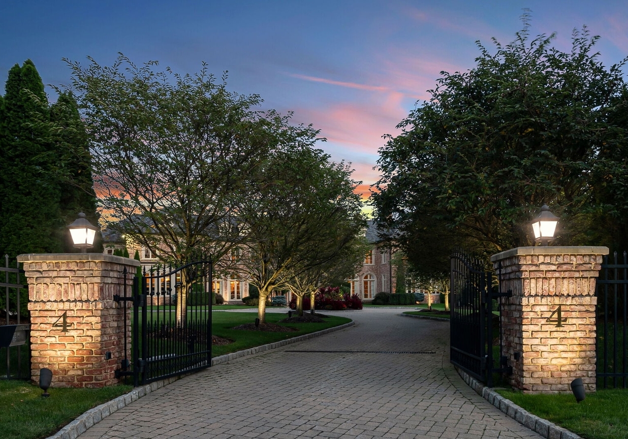 4 Stone Tower Drive Home in Alpine, New Jersey. Discover the epitome of luxury living at the majestic Alpine estate, one of the finest homes in Northern Bergen County. Set on 4 gated manicured acres in Rio Vista, this impeccably designed manor by James Paragono showcases architectural excellence and meticulous craftsmanship. With 22,782 square feet of opulent living space spread across 4 levels, this estate boasts 12' ceilings, luxurious amenities, and breathtaking features, including a pool, cabana, tennis court, guest house, and putting green. The residence offers garage parking for 8 cars, an elevator servicing all floors, 25 rooms, a new Salerno kitchen, 8 bedrooms, 9 full and 3 half baths, bowling alleys, a home theater, a commercial generator, and state-of-the-art high-efficiency furnaces.