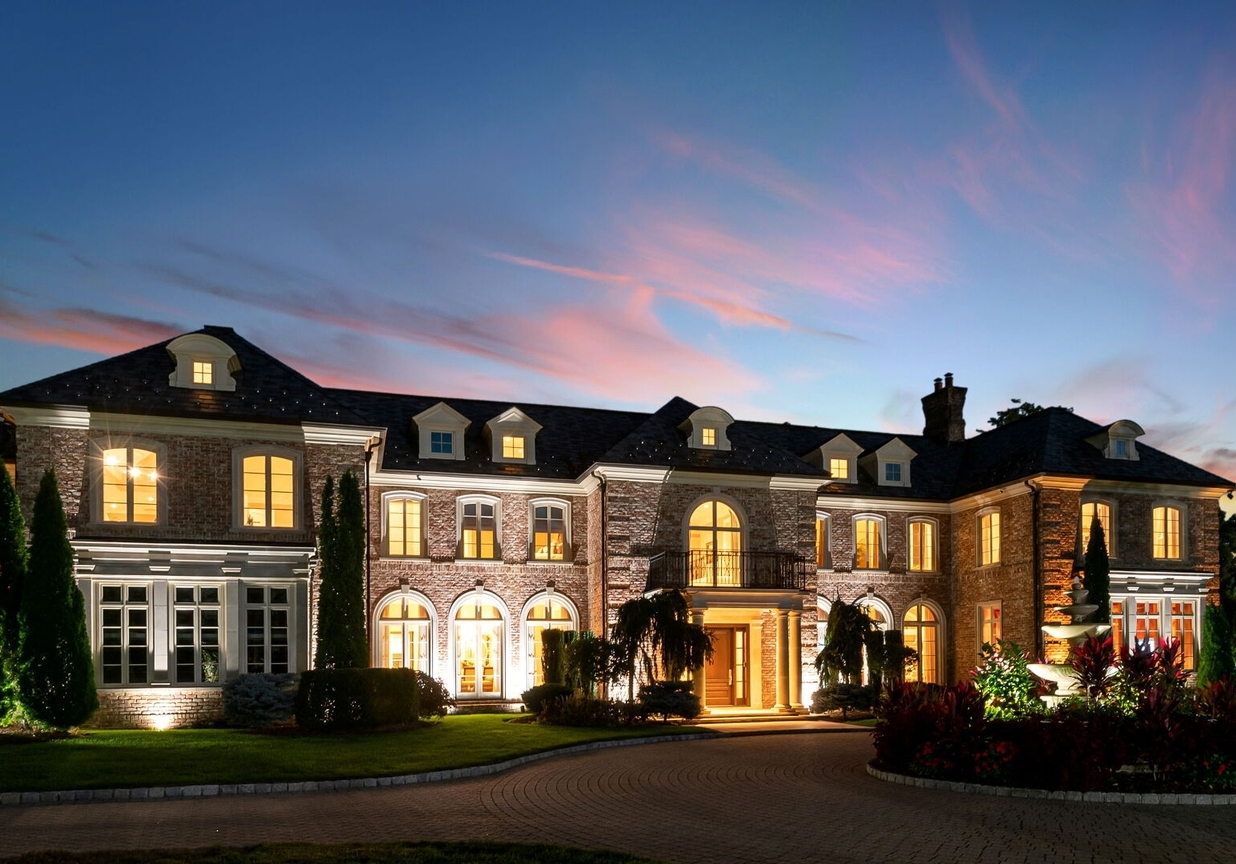 4 Stone Tower Drive Home in Alpine, New Jersey. Discover the epitome of luxury living at the majestic Alpine estate, one of the finest homes in Northern Bergen County. Set on 4 gated manicured acres in Rio Vista, this impeccably designed manor by James Paragono showcases architectural excellence and meticulous craftsmanship. With 22,782 square feet of opulent living space spread across 4 levels, this estate boasts 12' ceilings, luxurious amenities, and breathtaking features, including a pool, cabana, tennis court, guest house, and putting green. The residence offers garage parking for 8 cars, an elevator servicing all floors, 25 rooms, a new Salerno kitchen, 8 bedrooms, 9 full and 3 half baths, bowling alleys, a home theater, a commercial generator, and state-of-the-art high-efficiency furnaces.