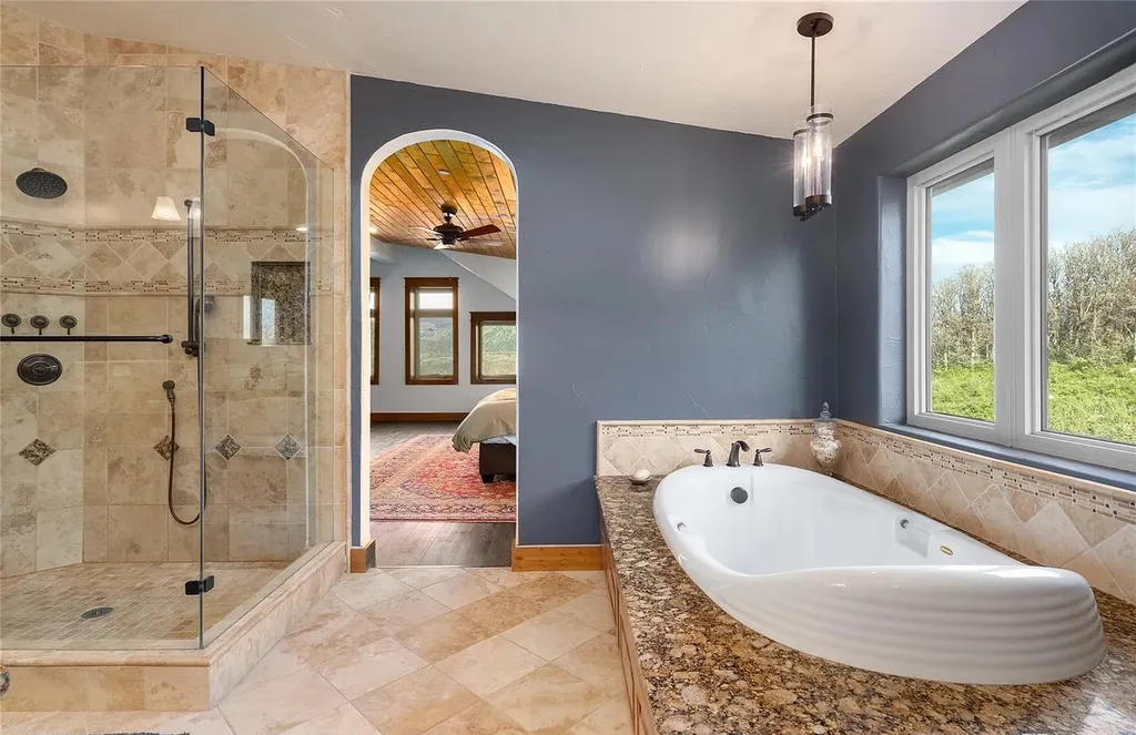 45200 Diamondback Way Home in Steamboat Springs, Colorado. Escape to a tranquil mountain retreat on Diamondback Way, offering breathtaking views and complete privacy just minutes from downtown Steamboat. This expansive property boasts 40 acres, hiking trails, and outdoor living spaces. The home features a great room with vaulted ceilings, a central kitchen for entertaining, and 6 bedrooms including primary suites. Enjoy the outdoors with a fire pit, hot tub, and acres of land for recreation. Horses are welcome, and the property has a high-producing well. Embrace the beauty of Steamboat's natural surroundings at this remarkable retreat.