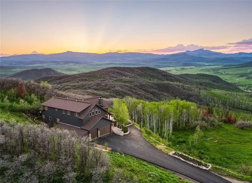 45200 Diamondback Way Home in Steamboat Springs, Colorado. Escape to a tranquil mountain retreat on Diamondback Way, offering breathtaking views and complete privacy just minutes from downtown Steamboat. This expansive property boasts 40 acres, hiking trails, and outdoor living spaces. The home features a great room with vaulted ceilings, a central kitchen for entertaining, and 6 bedrooms including primary suites. Enjoy the outdoors with a fire pit, hot tub, and acres of land for recreation. Horses are welcome, and the property has a high-producing well. Embrace the beauty of Steamboat's natural surroundings at this remarkable retreat.