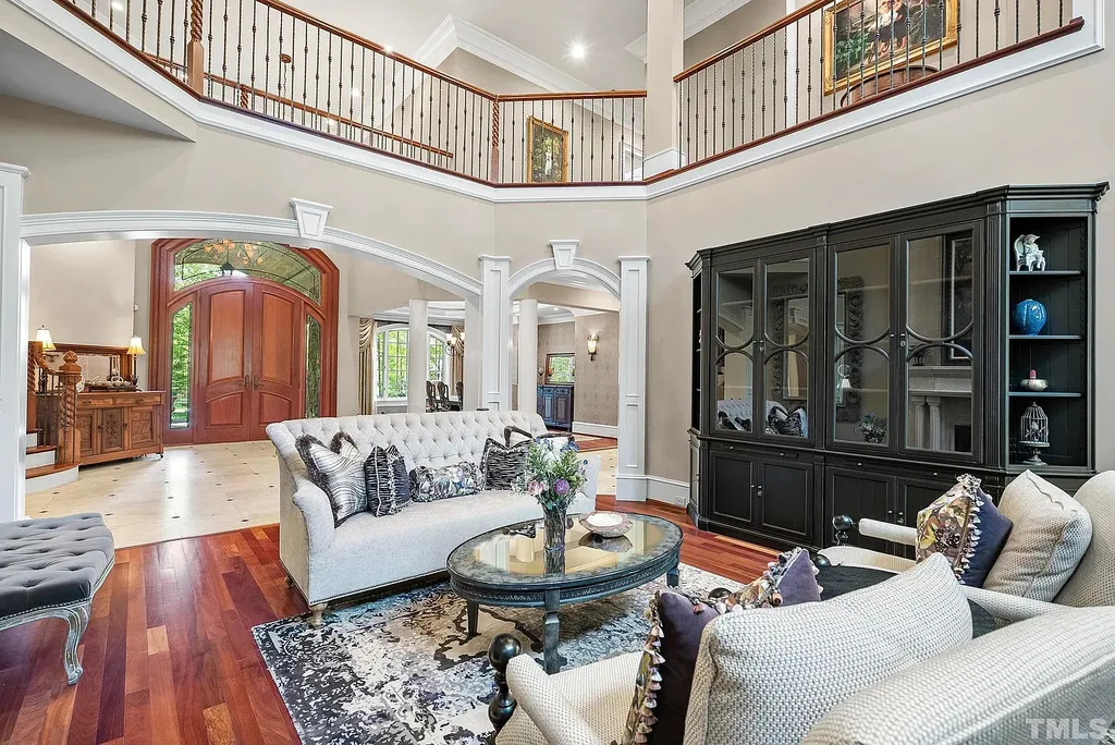 6040 Over Hadden Court Home in Raleigh, North Carolina. Indulge in the epitome of serenity and luxury at the prestigious Don Collins Estate. Nestled on 1.69 acres and embraced by the tranquil beauty of the Falls Lake wooded buffer, this remarkable residence offers an exquisite escape. Immerse yourself in timeless elegance, from the grand entrance with its stunning barreled ceiling to the imported stone accents, cathedral, coffered, and vaulted ceilings, travertine tile, and Brazilian cherry hardwood floors throughout the main level.