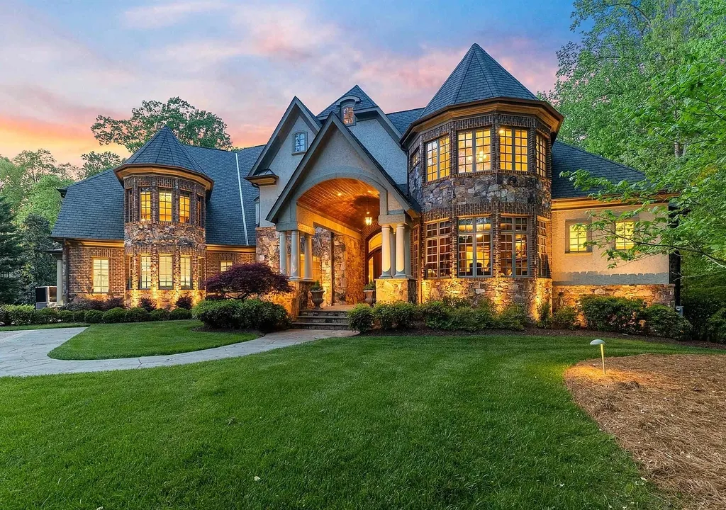 6040 Over Hadden Court Home in Raleigh, North Carolina. Indulge in the epitome of serenity and luxury at the prestigious Don Collins Estate. Nestled on 1.69 acres and embraced by the tranquil beauty of the Falls Lake wooded buffer, this remarkable residence offers an exquisite escape. Immerse yourself in timeless elegance, from the grand entrance with its stunning barreled ceiling to the imported stone accents, cathedral, coffered, and vaulted ceilings, travertine tile, and Brazilian cherry hardwood floors throughout the main level.