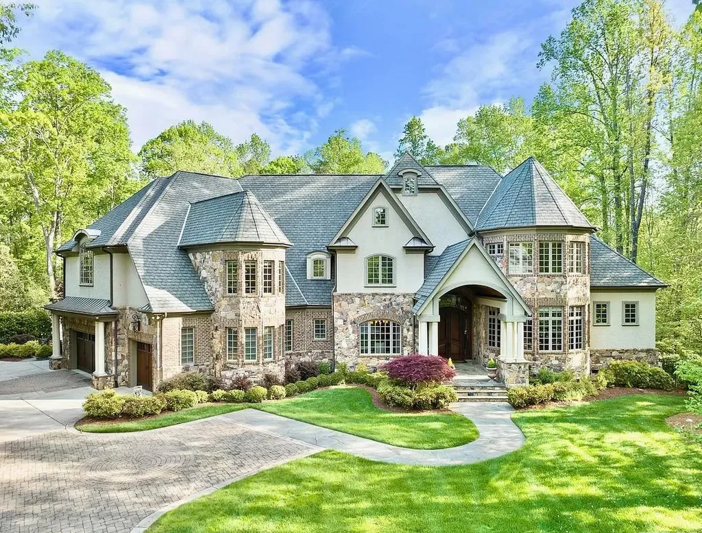 6040 Over Hadden Court Home in Raleigh, North Carolina. Indulge in the epitome of serenity and luxury at the prestigious Don Collins Estate. Nestled on 1.69 acres and embraced by the tranquil beauty of the Falls Lake wooded buffer, this remarkable residence offers an exquisite escape. Immerse yourself in timeless elegance, from the grand entrance with its stunning barreled ceiling to the imported stone accents, cathedral, coffered, and vaulted ceilings, travertine tile, and Brazilian cherry hardwood floors throughout the main level.