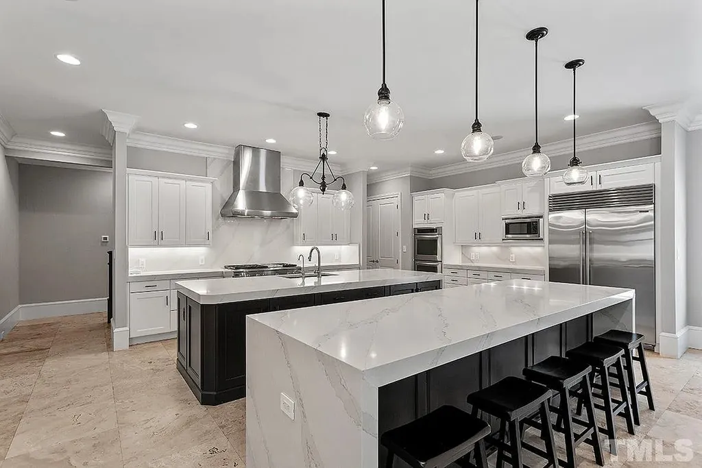 6205 Autrey Court Home in Raleigh, North Carolina. Experience the ultimate staycation in this magnificent home that exudes elegance and offers a host of luxurious features. A recent kitchen refresh showcases stunning quartz countertops and backsplash, complemented by new appliances. The integration of Control 4 Home Automation allows for seamless control of various systems within the home. Fresh paint, updated fixtures, and new carpet throughout create a fresh and inviting ambiance.