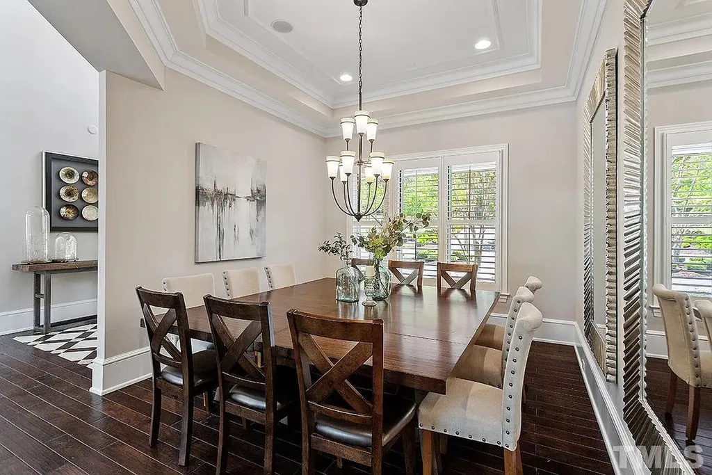 6205 Autrey Court Home in Raleigh, North Carolina. Experience the ultimate staycation in this magnificent home that exudes elegance and offers a host of luxurious features. A recent kitchen refresh showcases stunning quartz countertops and backsplash, complemented by new appliances. The integration of Control 4 Home Automation allows for seamless control of various systems within the home. Fresh paint, updated fixtures, and new carpet throughout create a fresh and inviting ambiance.