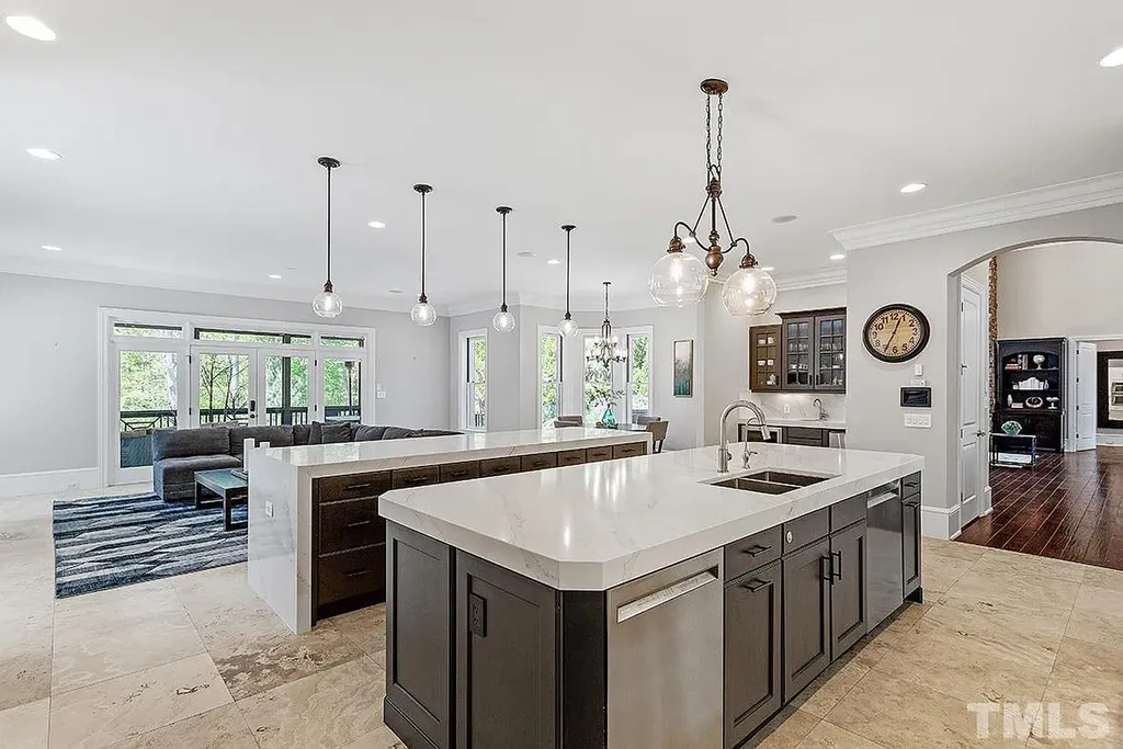 6205 Autrey Court Home in Raleigh, North Carolina. Experience the ultimate staycation in this magnificent home that exudes elegance and offers a host of luxurious features. A recent kitchen refresh showcases stunning quartz countertops and backsplash, complemented by new appliances. The integration of Control 4 Home Automation allows for seamless control of various systems within the home. Fresh paint, updated fixtures, and new carpet throughout create a fresh and inviting ambiance.