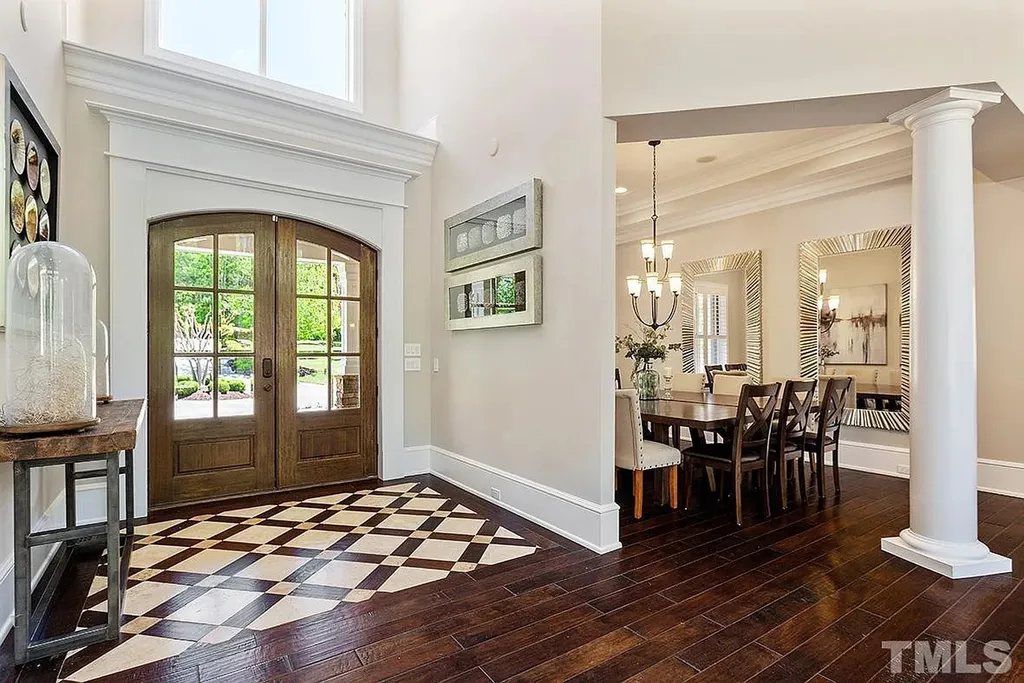 6205 Autrey Court Home in Raleigh, North Carolina. Experience the ultimate staycation in this magnificent home that exudes elegance and offers a host of luxurious features. A recent kitchen refresh showcases stunning quartz countertops and backsplash, complemented by new appliances. The integration of Control 4 Home Automation allows for seamless control of various systems within the home. Fresh paint, updated fixtures, and new carpet throughout create a fresh and inviting ambiance.