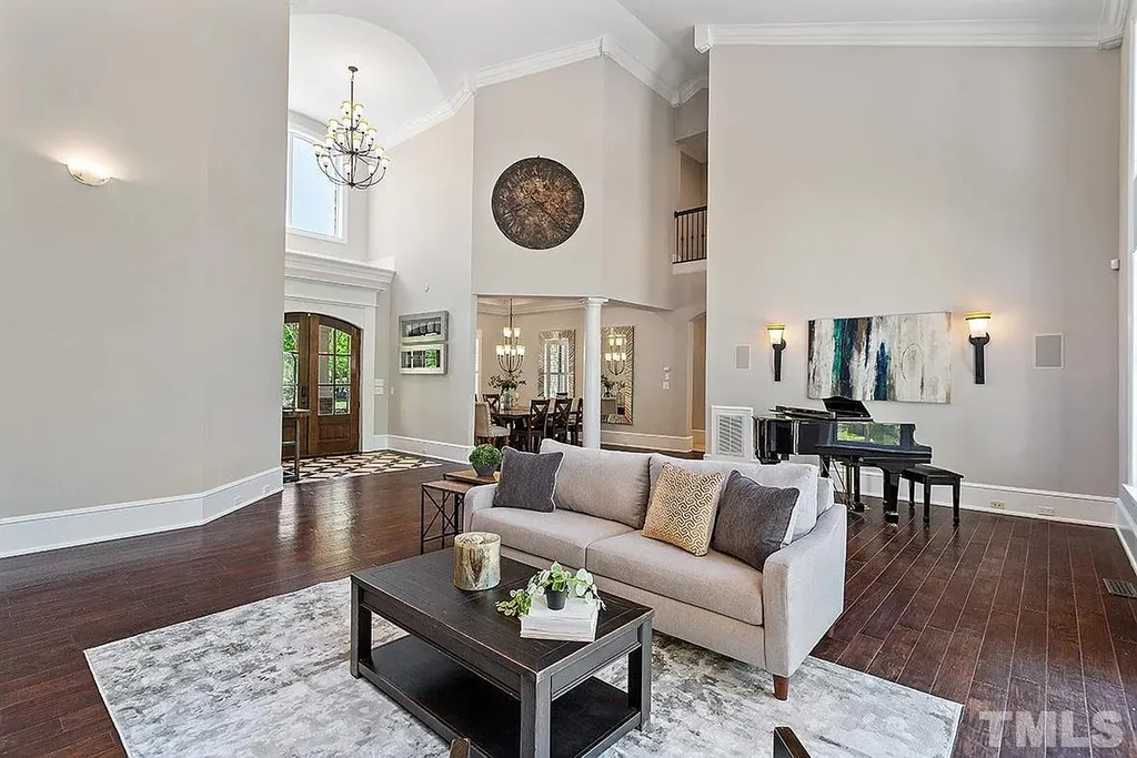 6205 Autrey Court Home in Raleigh, North Carolina. Experience the ultimate staycation in this magnificent home that exudes elegance and offers a host of luxurious features. A recent kitchen refresh showcases stunning quartz countertops and backsplash, complemented by new appliances. The integration of Control 4 Home Automation allows for seamless control of various systems within the home. Fresh paint, updated fixtures, and new carpet throughout create a fresh and inviting ambiance.