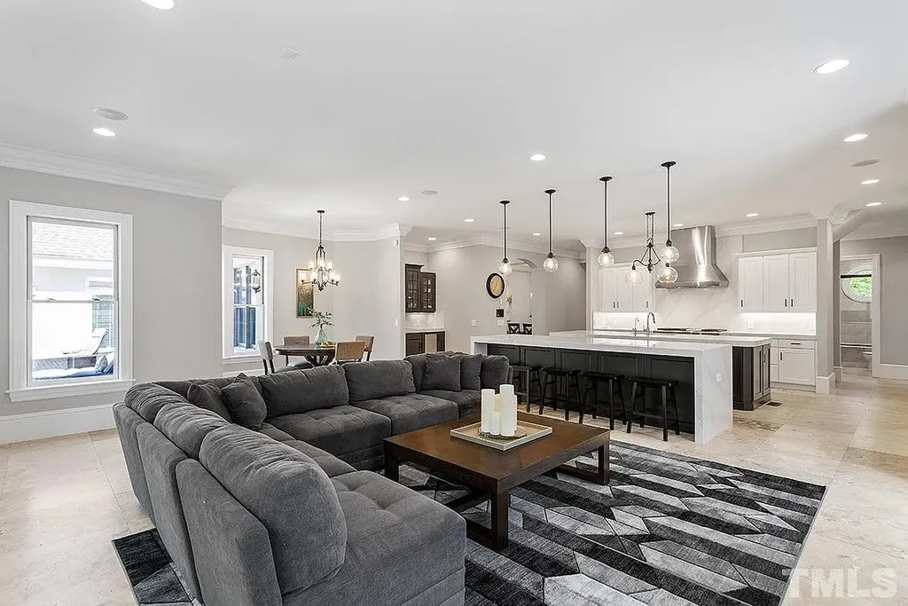 6205 Autrey Court Home in Raleigh, North Carolina. Experience the ultimate staycation in this magnificent home that exudes elegance and offers a host of luxurious features. A recent kitchen refresh showcases stunning quartz countertops and backsplash, complemented by new appliances. The integration of Control 4 Home Automation allows for seamless control of various systems within the home. Fresh paint, updated fixtures, and new carpet throughout create a fresh and inviting ambiance.