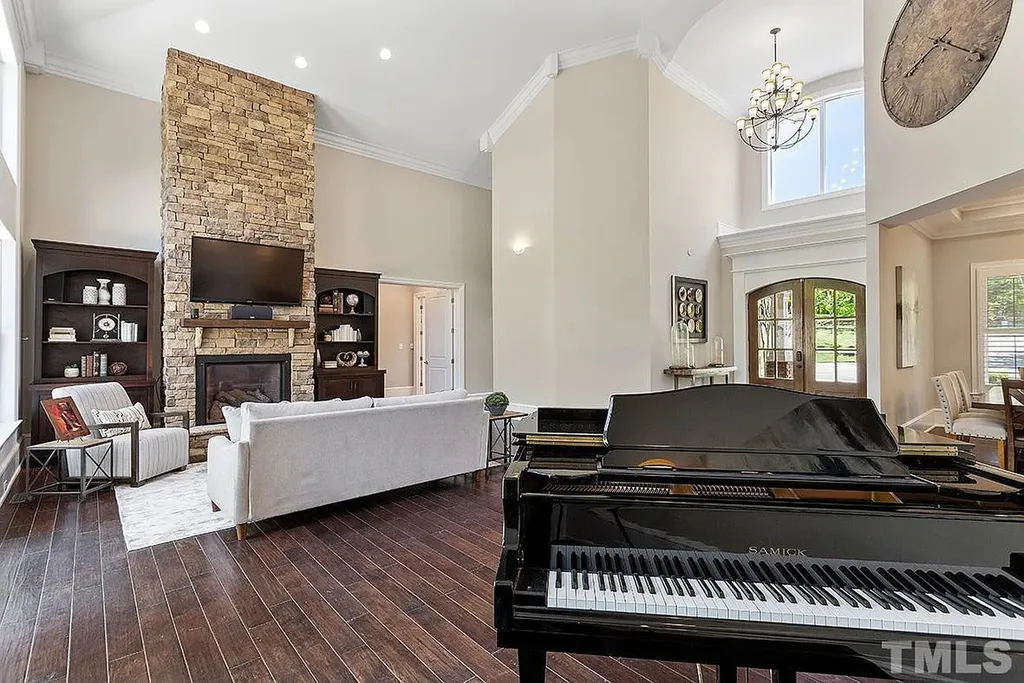 6205 Autrey Court Home in Raleigh, North Carolina. Experience the ultimate staycation in this magnificent home that exudes elegance and offers a host of luxurious features. A recent kitchen refresh showcases stunning quartz countertops and backsplash, complemented by new appliances. The integration of Control 4 Home Automation allows for seamless control of various systems within the home. Fresh paint, updated fixtures, and new carpet throughout create a fresh and inviting ambiance.