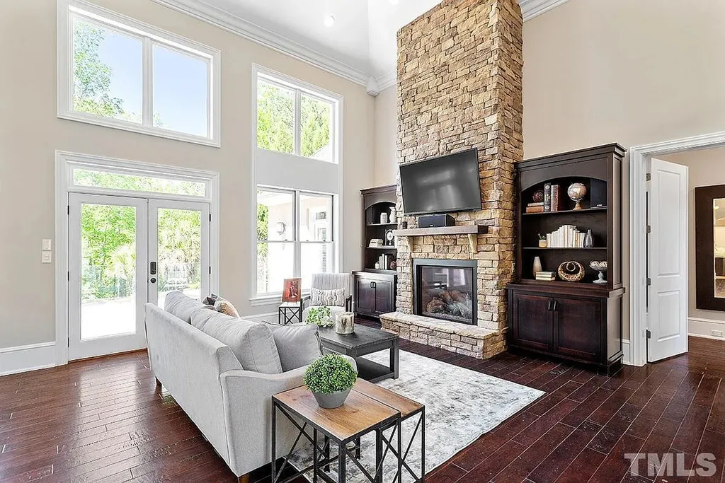 6205 Autrey Court Home in Raleigh, North Carolina. Experience the ultimate staycation in this magnificent home that exudes elegance and offers a host of luxurious features. A recent kitchen refresh showcases stunning quartz countertops and backsplash, complemented by new appliances. The integration of Control 4 Home Automation allows for seamless control of various systems within the home. Fresh paint, updated fixtures, and new carpet throughout create a fresh and inviting ambiance.