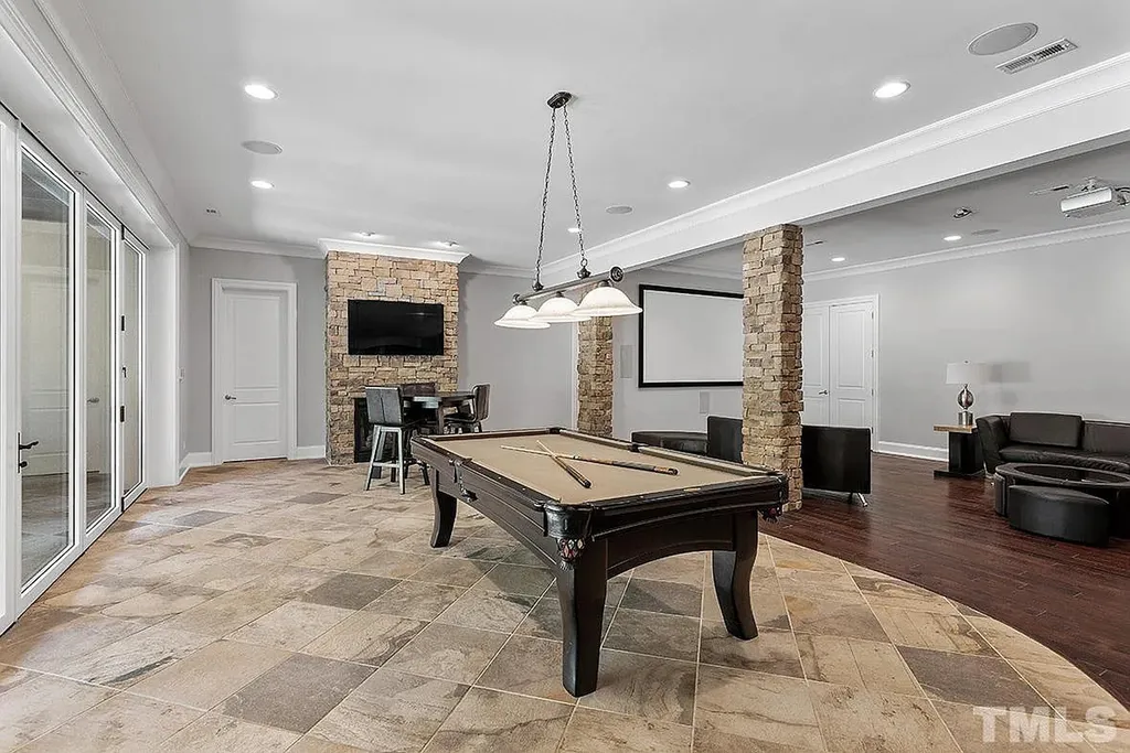 6205 Autrey Court Home in Raleigh, North Carolina. Experience the ultimate staycation in this magnificent home that exudes elegance and offers a host of luxurious features. A recent kitchen refresh showcases stunning quartz countertops and backsplash, complemented by new appliances. The integration of Control 4 Home Automation allows for seamless control of various systems within the home. Fresh paint, updated fixtures, and new carpet throughout create a fresh and inviting ambiance.