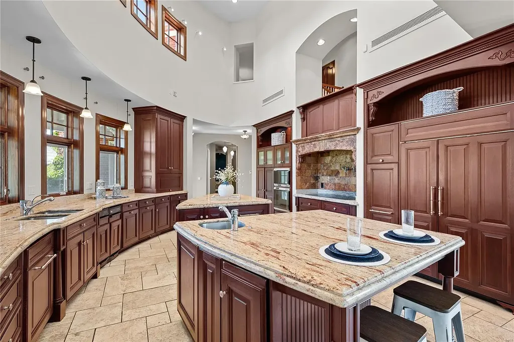 7 Hillside Court Home in Wentzville, Missouri. Prepare for a life-changing experience in this remarkable home that transcends conventional expectations. Embrace the embrace over 20,000 sq. ft. of "Luxury Meant to be Lived In," meticulously designed to cater to multigenerational families, offering abundant space for all. Situated on a vast 20+ acre property (expandable up to 130 acres), this estate presents a plethora of amenities including stables, a sports field, playground, Ferris wheel, event/sports venue, raised bed gardens, and a resort-worthy pool featuring racing slides, a swim-up bar, lazy river, waterfall-covered grotto, dive board, and a zero-edge entry.