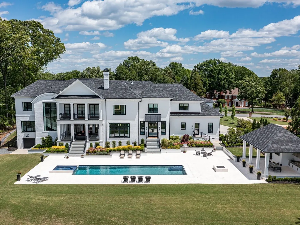 7214 Baltusrol Lane Home in Charlotte, North Carolina. Recently renovated with custom details, including Canadian Black Walnut hardwoods and Italian Calacatta marble, this home exudes elegance. The chef's kitchen, luxurious primary suite, and outdoor entertainment area with a pool and fireplace make this home the epitome of luxury. With a 3-car garage and golf cart bay, it caters to every need. Don't miss this opportunity to own a truly remarkable property.