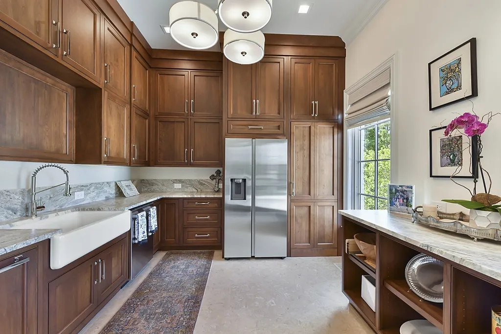 7214 Baltusrol Lane Home in Charlotte, North Carolina. Recently renovated with custom details, including Canadian Black Walnut hardwoods and Italian Calacatta marble, this home exudes elegance. The chef's kitchen, luxurious primary suite, and outdoor entertainment area with a pool and fireplace make this home the epitome of luxury. With a 3-car garage and golf cart bay, it caters to every need. Don't miss this opportunity to own a truly remarkable property.