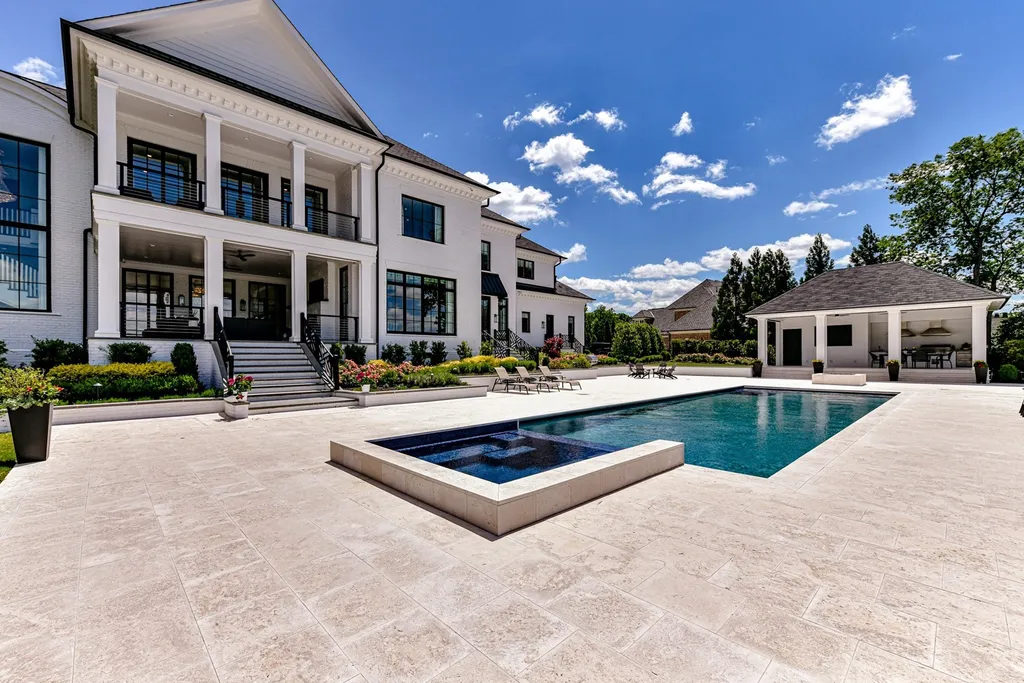 7214 Baltusrol Lane Home in Charlotte, North Carolina. Recently renovated with custom details, including Canadian Black Walnut hardwoods and Italian Calacatta marble, this home exudes elegance. The chef's kitchen, luxurious primary suite, and outdoor entertainment area with a pool and fireplace make this home the epitome of luxury. With a 3-car garage and golf cart bay, it caters to every need. Don't miss this opportunity to own a truly remarkable property.