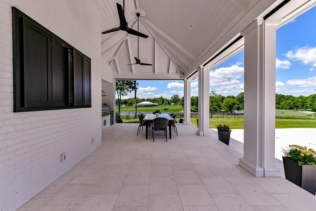 7214 Baltusrol Lane Home in Charlotte, North Carolina. Recently renovated with custom details, including Canadian Black Walnut hardwoods and Italian Calacatta marble, this home exudes elegance. The chef's kitchen, luxurious primary suite, and outdoor entertainment area with a pool and fireplace make this home the epitome of luxury. With a 3-car garage and golf cart bay, it caters to every need. Don't miss this opportunity to own a truly remarkable property.