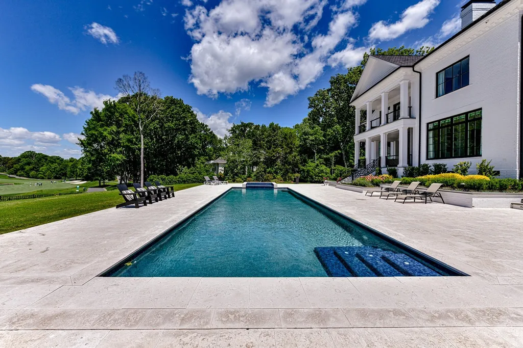 7214 Baltusrol Lane Home in Charlotte, North Carolina. Recently renovated with custom details, including Canadian Black Walnut hardwoods and Italian Calacatta marble, this home exudes elegance. The chef's kitchen, luxurious primary suite, and outdoor entertainment area with a pool and fireplace make this home the epitome of luxury. With a 3-car garage and golf cart bay, it caters to every need. Don't miss this opportunity to own a truly remarkable property.